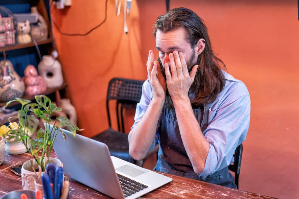 Smart Web Creative - Wix vs. Hiring a Web Designer: What Southern California Small Businesses Should Know - frustrated entrepeneur DIY laptop home office