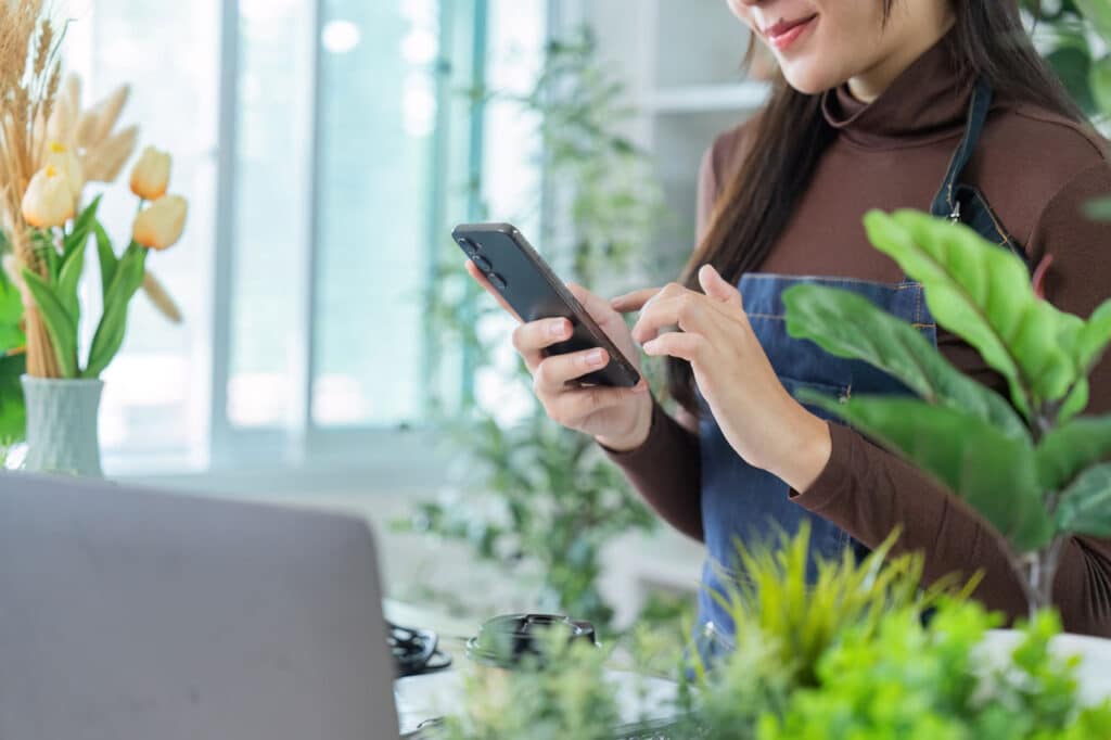Smart Web Creative - Small business owner managing website on mobile device